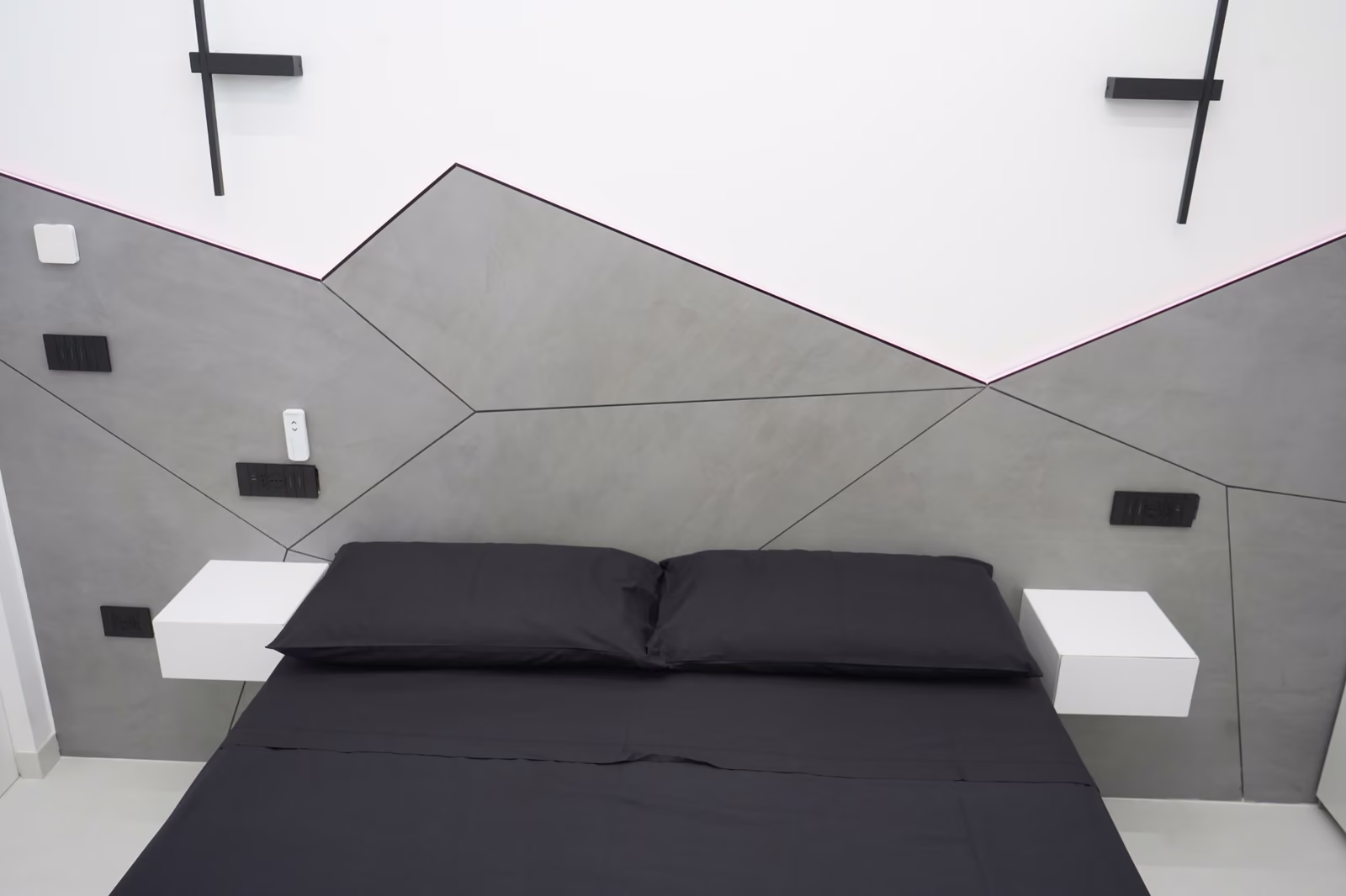 Rivestimento geometrico dietro la testata di un letto